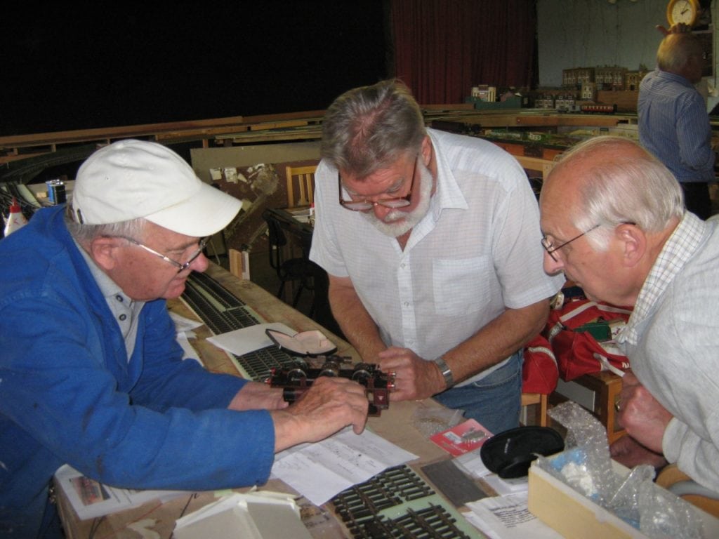 Joe Barron, Barry Watson and Maurice Baker examine a MR loco. [Rob Moody]